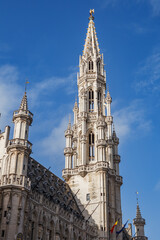 Fototapeta na wymiar Spire of the Town Hall building at the center of the ornate, gothic, historic Grand Place city square in downtown Brussels, Belgium