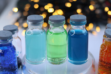 Three small glass jars with solutions of indicator dyes: blue, green and dark blue.
