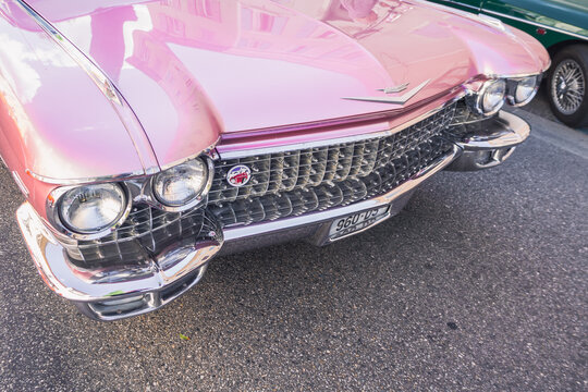 Loriol sur Drome, France - 17 September, 2022: Front of the Vintage pink Cadillac Coupe DeVille 1962 Series 62 on the street. Classic car exhibition in Loriol sur Drome, France.