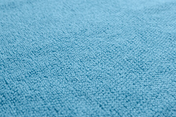 Fototapeta na wymiar Dry soft blue towel as background, closeup