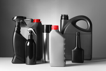 Different bottles of car products on white table