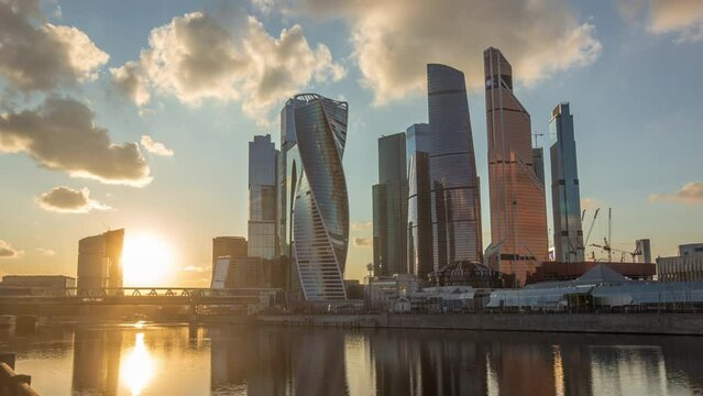 Sunset at Moscow City business center skyscrapers office buildings and luxury apartments timelapse hyperlapse. Orange clouds over towers evening panorama. Modern european architecture