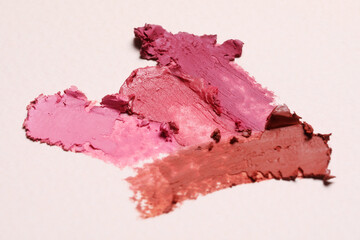 Smears of beautiful lipsticks on light background, closeup