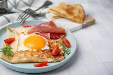 Delicious crepe with egg served on white tiled table. Breton galette