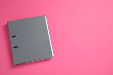 Grey office folder on pink background, top view. Space for text