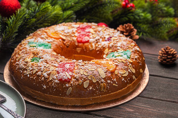 Roscon is a traditional Spanish Christmas pastry on the dark wooden background