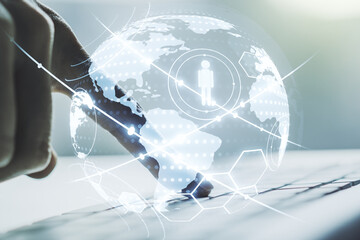 Social network concept with world map and hands typing on laptop on background. Multiexposure
