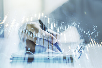 Multi exposure of abstract financial graph with hand writing in notebook on background, financial and trading concept