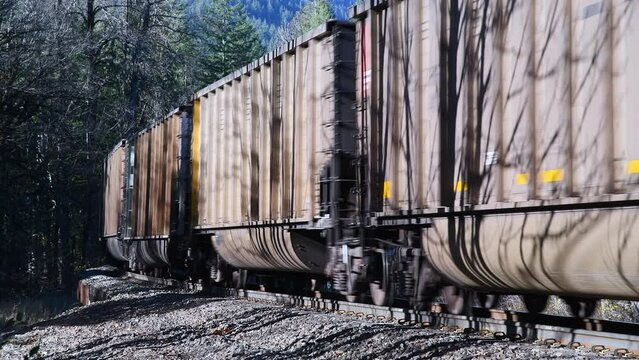Empty coal train passing in closeup as it turn a bend in the track in the United States