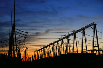 Fototapeta na wymiar High voltage power grid, in the sunset