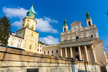 Fototapeta premium Impressive Baroque building of Lublin Cathedral and Trinitarian Tower on background of blue spring sky, Poland