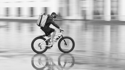 Blurred silhouette of a cyclist on a city street