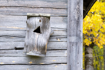 Wooden nest box on a wall in a farmstead in Finland, Northern Europe