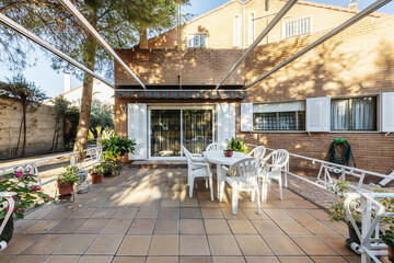 Backyard of a villa with dining room with matching table and chairs