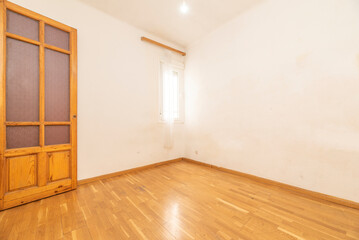 Empty room with French oak parquet flooring and solid pine wood doors with purple opaque glass