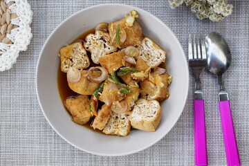 Tahu gejrot is traditional street food made from fried tofu (bean curd) with crushed shallot and green chili in sweet soy and sugar sauce. Typically food from Cirebon, West Java.