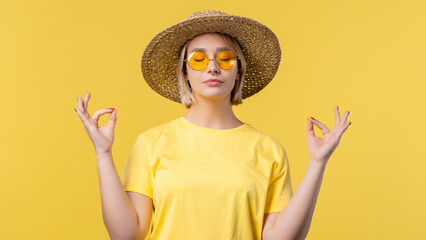 Calm woman relaxing, meditating, refuses stress. Sunny girl breathes deeply, calms down yellow...