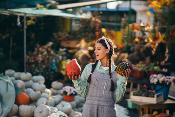 A young female seller is showing the autumn harvest