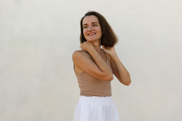 Portrait of a young beautiful woman on a light background