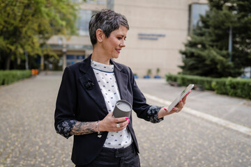 one woman mature senior caucasian female use digital tablet outdoor