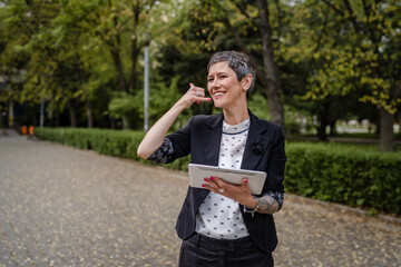 one woman mature senior caucasian female use digital tablet outdoor