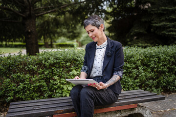 Fototapeta premium one woman mature senior caucasian female use digital tablet outdoor