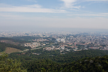 Vista Oeste do Parque Estadual do Jaraguá - SAO PAULO, SP, BRAZIL - NOVEMBER 13, 2022: View of the west side of the city from the peak of Jaragua, with the Bandeirantes highway in the center.