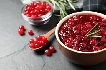 Cranberry sauce in bowl on dark grey table