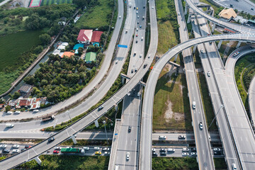 Naklejka premium Multilevel junction motorway top view, Road traffic an important infrastructure in Thailand.Expressway Road and Roundabout. Transportation and travel concept.