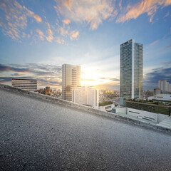 Uphill asphalt road with modern buildings and skyscrapers