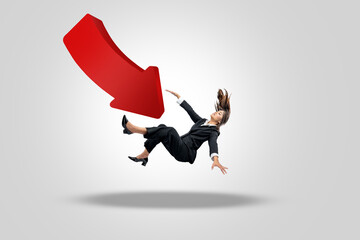Asian businesswoman falling on down arrow