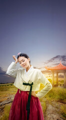 Asian woman wearing a traditional Korean national costume, Hanbok, feeling headache on the field