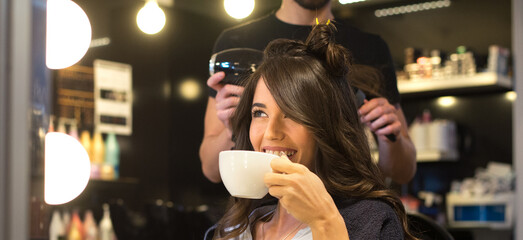 Young woman getting new hairstyle from hairdresser in the modern hair salon	 - 551706297