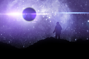 a silhouette of a person standing on top of mountain and watch the sky galaxy. elements of this...