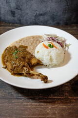 white beans with chicken and beef, served with rice and red onion seasoned