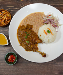white beans with chicken and beef, served with rice and red onion seasoned