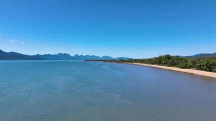 Aerial over a sun drenched tropical beach at Cardwell Queensland Australia