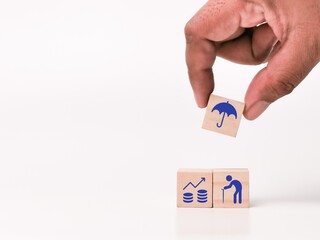 Concept of retirement plan and insurance on wooden cubes with hand.