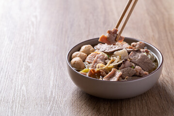 Rice noodles soup with pork eating by chopsticks, Asian food