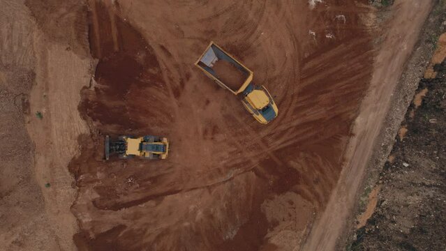 Top down view of volvo wheel loaders + A30G articulated hauler - heavy earthwork construction #008