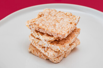 A Stack of Square Rice Cakes on White Plate. Dietary Crispbread