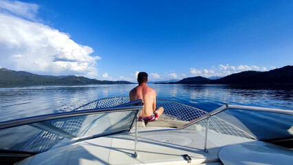 A man sitting in a boat taking a good time