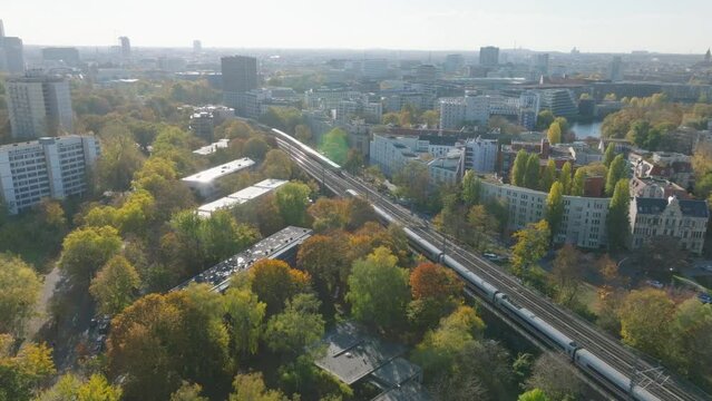 Aerial view of trains passing by each other on multitrack railway line in autumn city. Berlin, Germany
