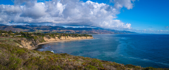 Fototapeta na wymiar Point Dume promontory seascape and dramatic cloudscape on the coast of Malibu, California, with the view of Paradise Cove Beach in Laguna Point to Latigo Point Area of Special Biological Significance