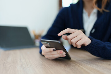 business owner or Asian female marketers are using business phones in office work