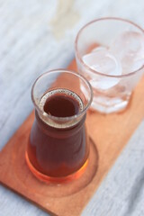 a glass of black coffe made using japanese technique and ice cubes in the morning