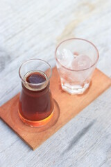 a glass of black coffe made using japanese technique and ice cubes in the morning