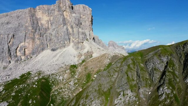 Beautiful Dolomite mountain landscape on sunny summer day with blue sky, aerial dolly zoom