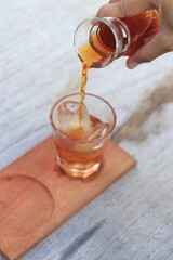 a glass of black coffe made using japanese technique and ice cubes in the morning