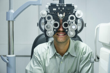 Man having eye test using phoropter.